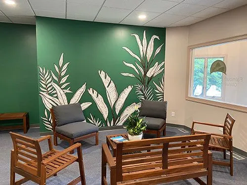 Waiting room with a hand-painted botanical mural